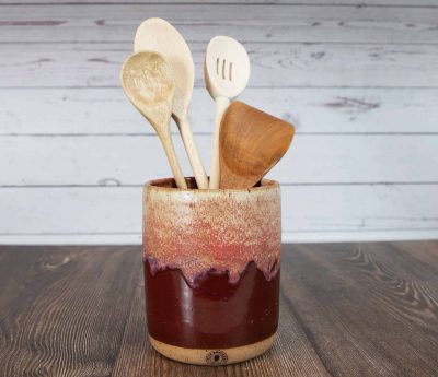 reddish brown utensil holder full of utensils