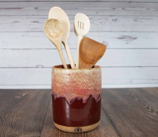 reddish brown utensil holder full of utensils