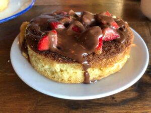 pancake covered in strawberries and chocolate sauce at five oaks farm kitchen