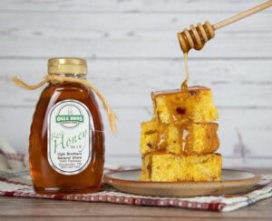 ogle brothers raw honey and cornbread being drizzled in honey